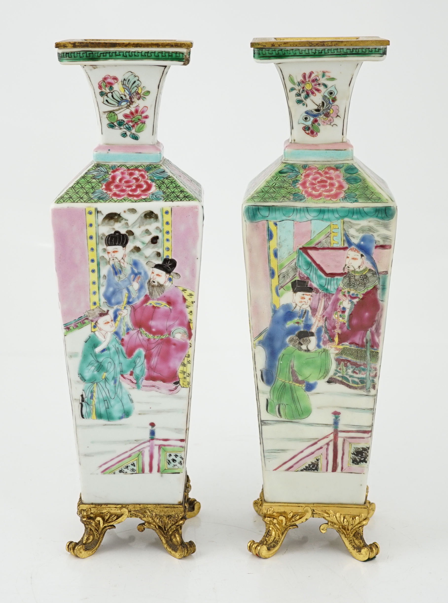 A pair of Chinese famille rose square baluster vases, late 19th/early 20th century, with European gilt metal mounts, each painted with figure scenes, total height 32cm